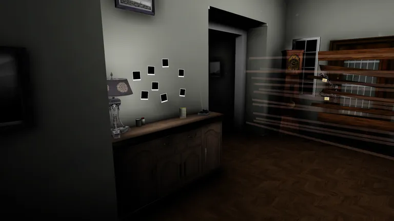 A dim room with photos pinned on the wall and a boarded-up cabinet