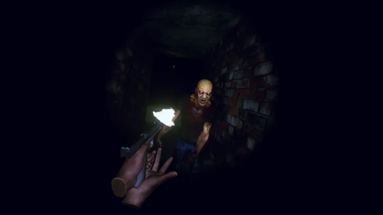 The player fires a pistol at a zombie in a dark brick tunnel